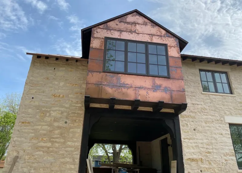 Copper metal panel facade on a stone building for Roof Repair in Camp Springs